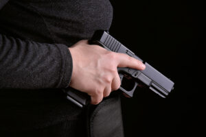 Utah concealed firearms permit - hand removing gun from holster